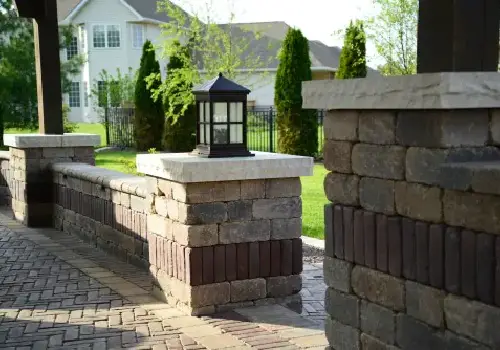 A brick wall created by Mark Hoerr Landscaping for a backyard landscape design
