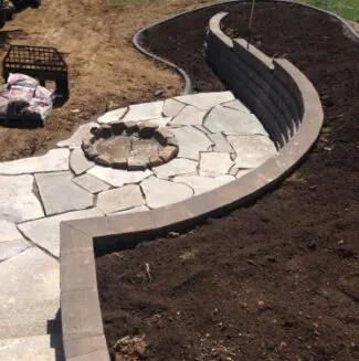Professional grading and a stone wall, with work done by Mark Hoerr Landscaping