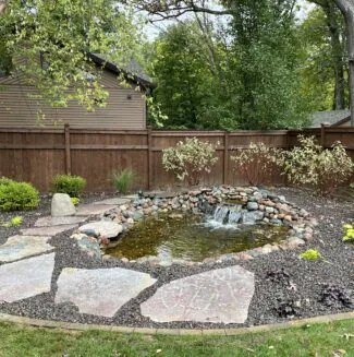 A pond and waterfall, a water feature designed by Mark Hoerr Landscaping