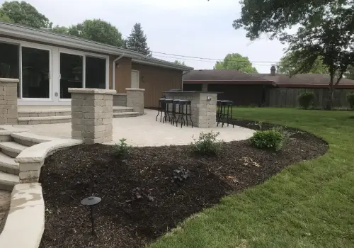 A backyard with a new patio designed and installed by Mark Hoerr Landscaping