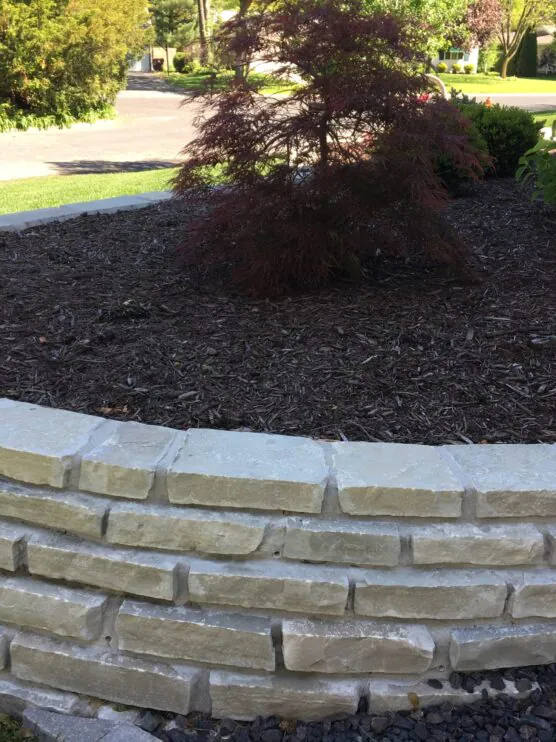 A retaining wall around a garden, installed by Mark Hoerr Landscaping