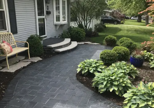 Shrubs next to a beautiful patio and manicured lawn, all part of Mark Hoerr's landscaping & ground work services for Peoria homeowners