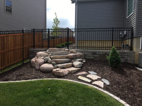 Landscaper in Washington IL showcasing front yard hardscaping with stone steps and clean design