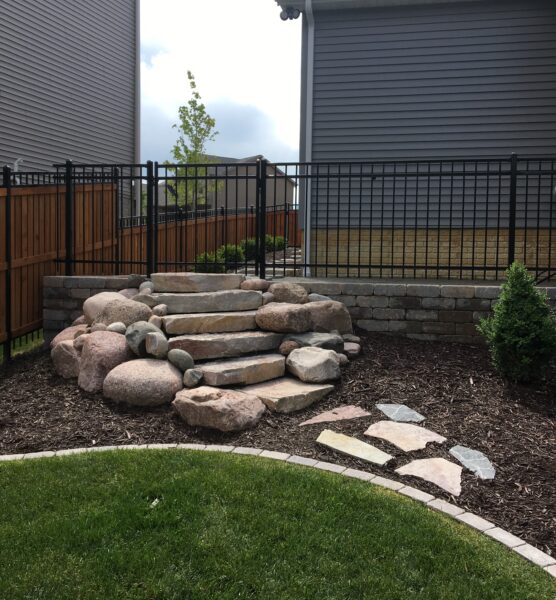 Landscaper in Washington IL showcasing front yard hardscaping with stone steps and clean design