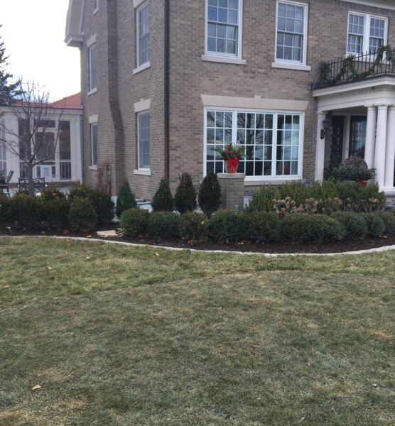A stunning residential yard transformation featuring custom plantings by a professional landscaper East Peoria IL.